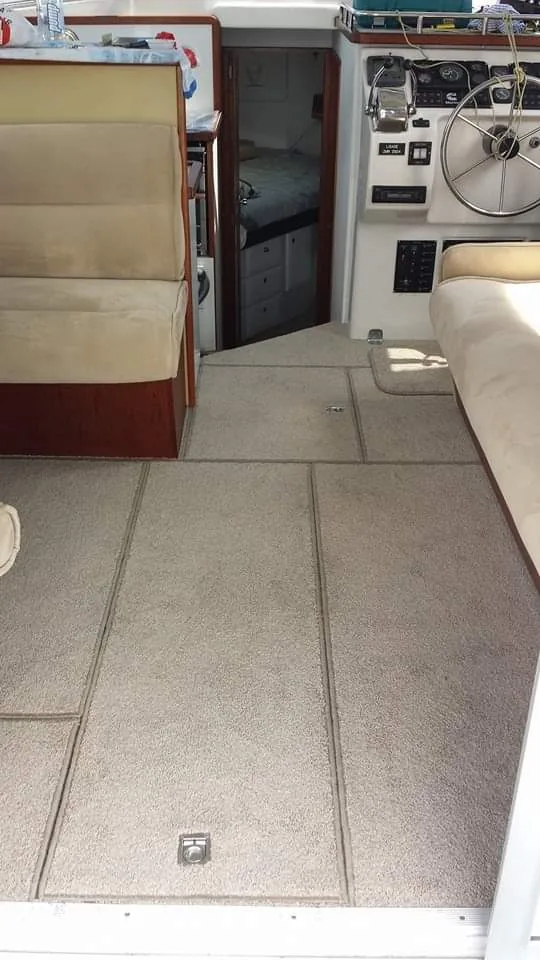 Custom tan marine carpet with overlocked edges fitted inside a boat cabin
