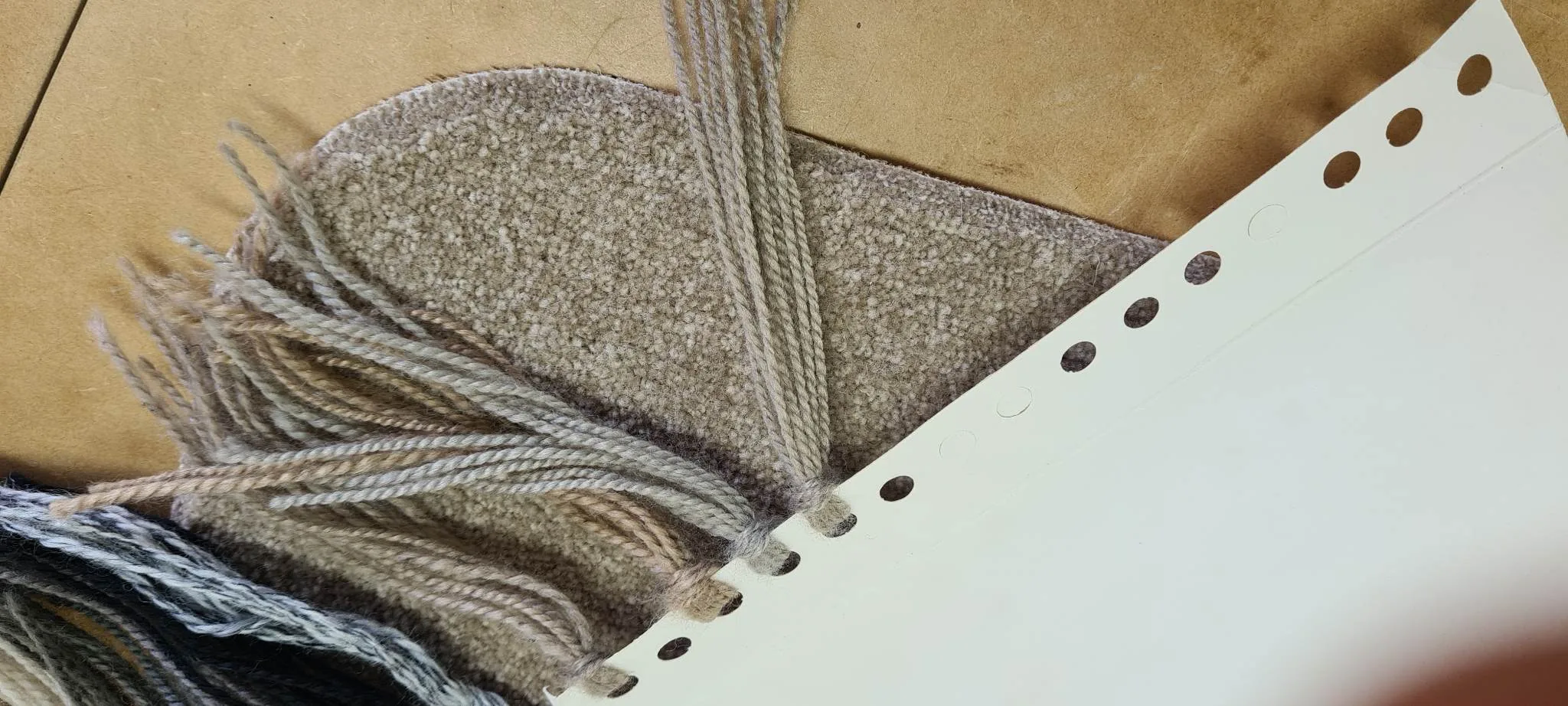Yarn colour samples matched to beige carpet for overlocking