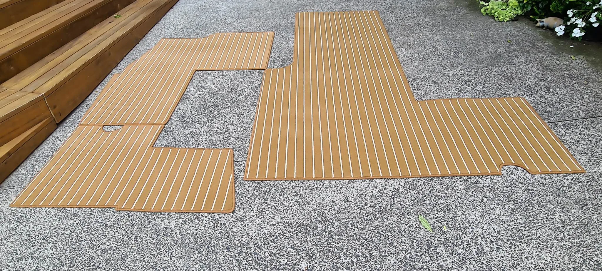 Custom teak-style marine deck carpet with overlocked edges for boats
