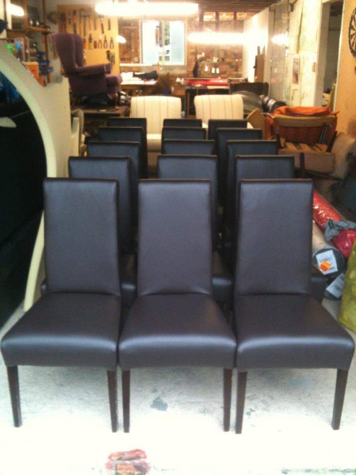Commercial dining chairs upholstered in dark vinyl